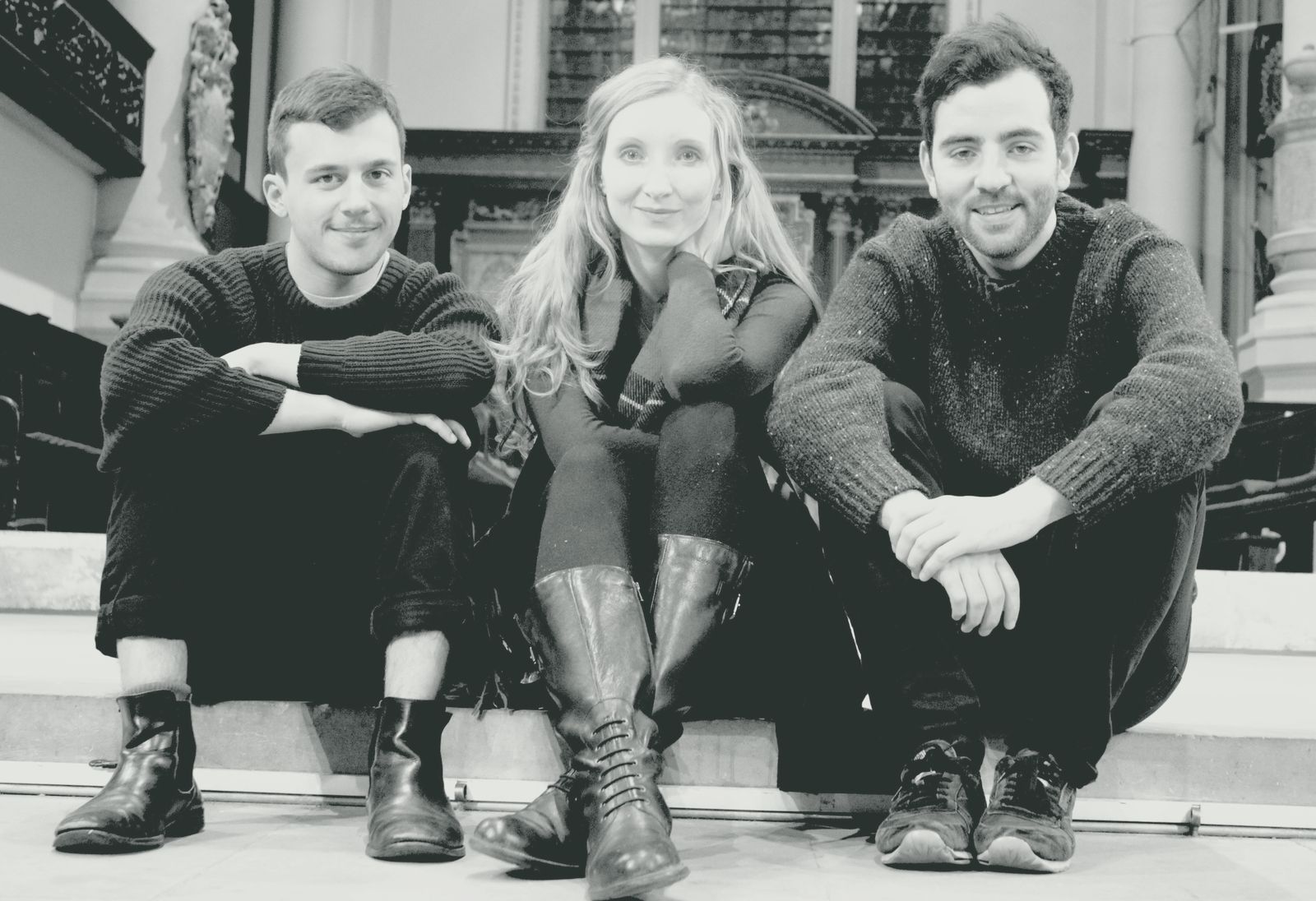 The trio sitting together on the chancel steps of a church